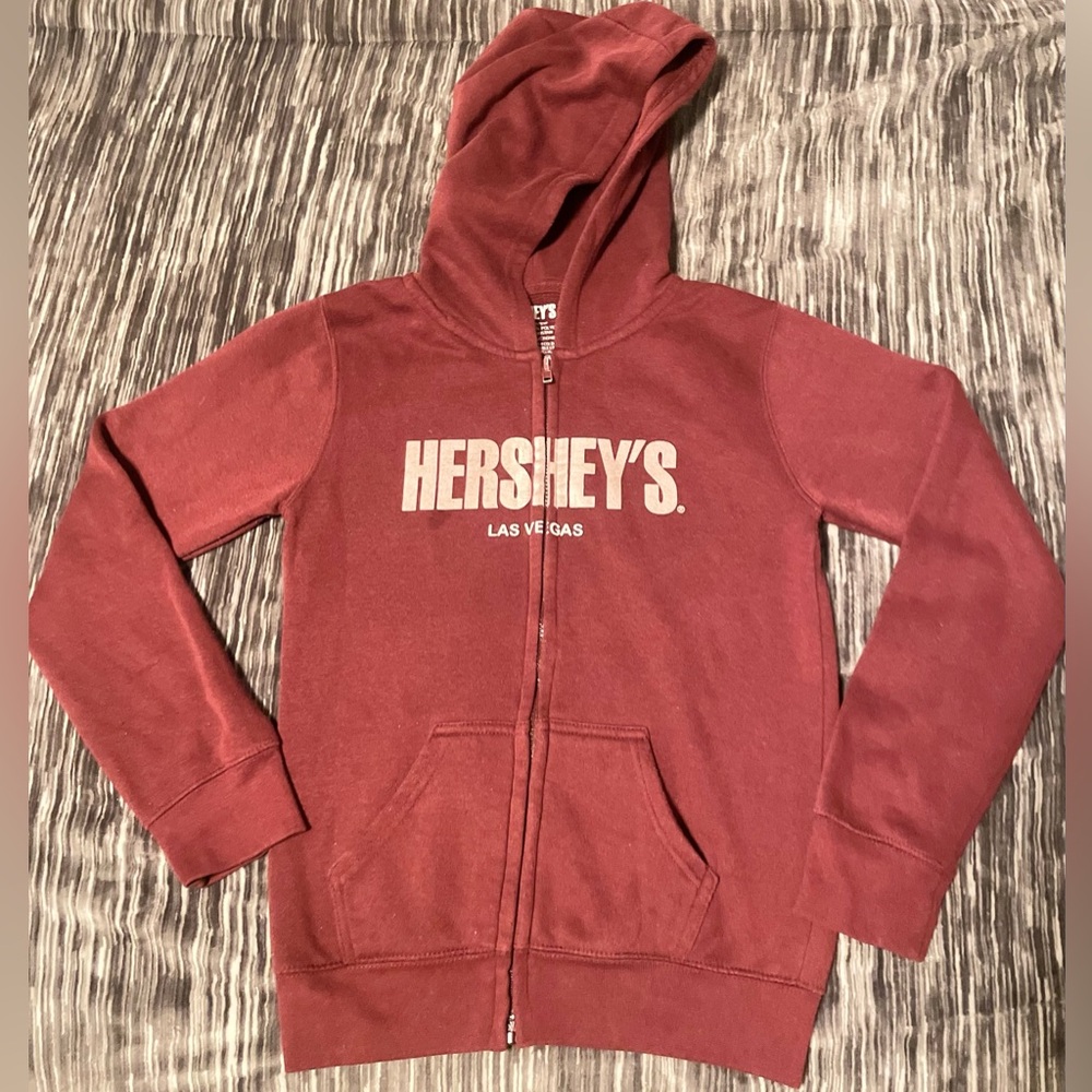 Hershey's zip up hoodie.  Dark purple/red color. Has front pockets. Youth Large